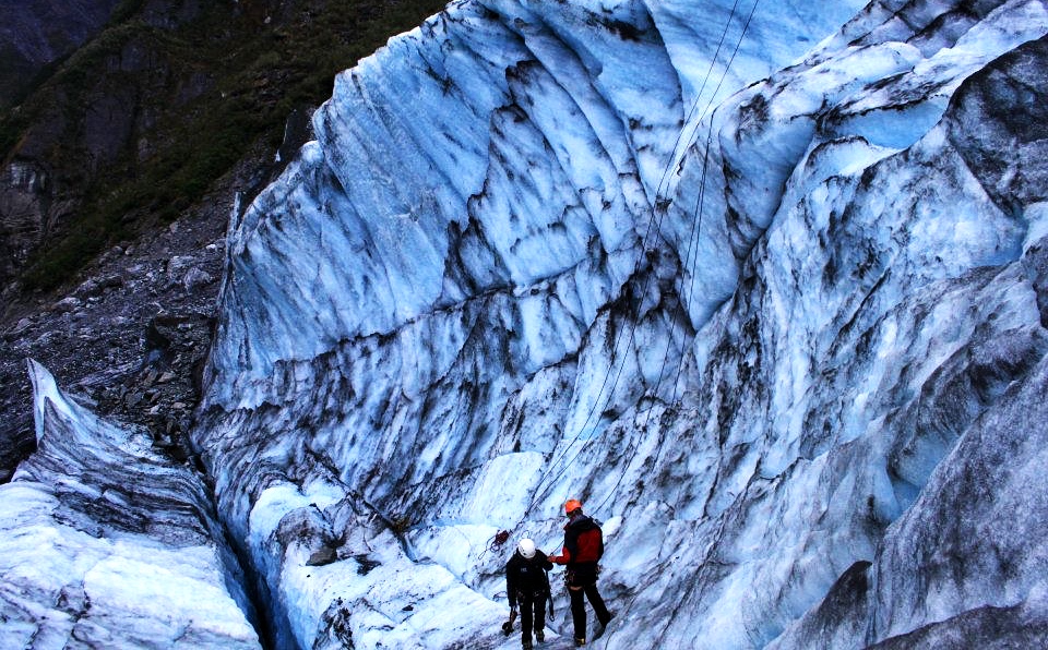 climbing a wall of ice in fox glacier New Zealand